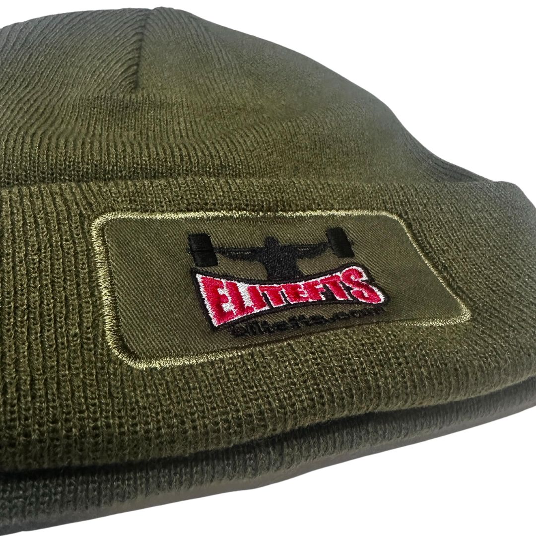 Green knit beanie with a logo patch on a white background