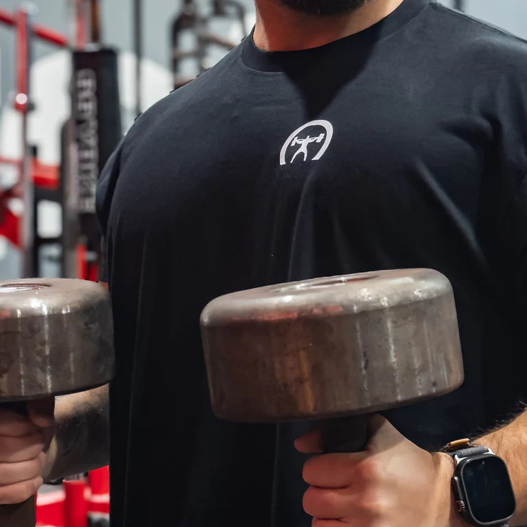 Person lifting dumbbells in a gym setting-all-groups