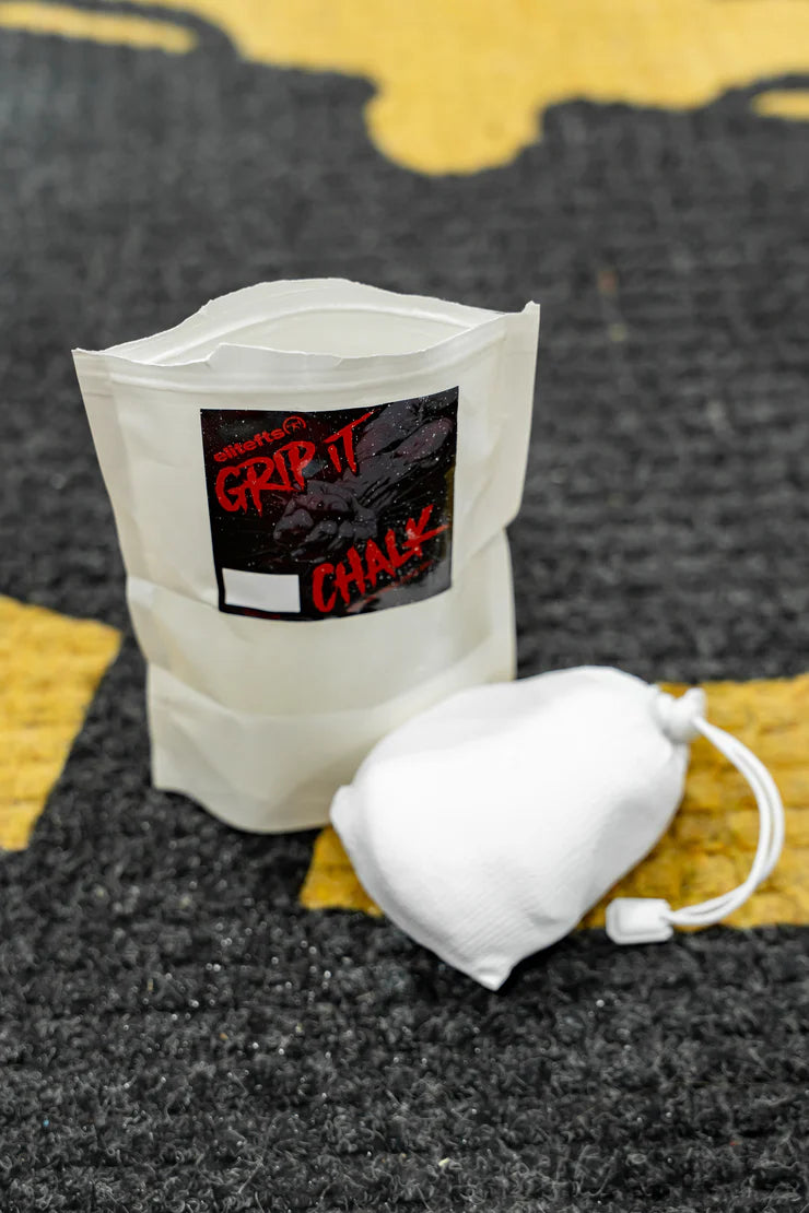 Bag of grip chalk and a container on a textured surface