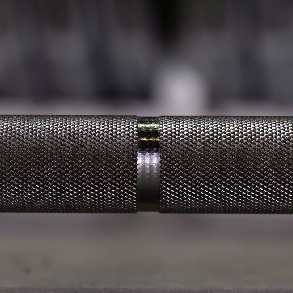 Close-up of a textured metal bar with a blurred background