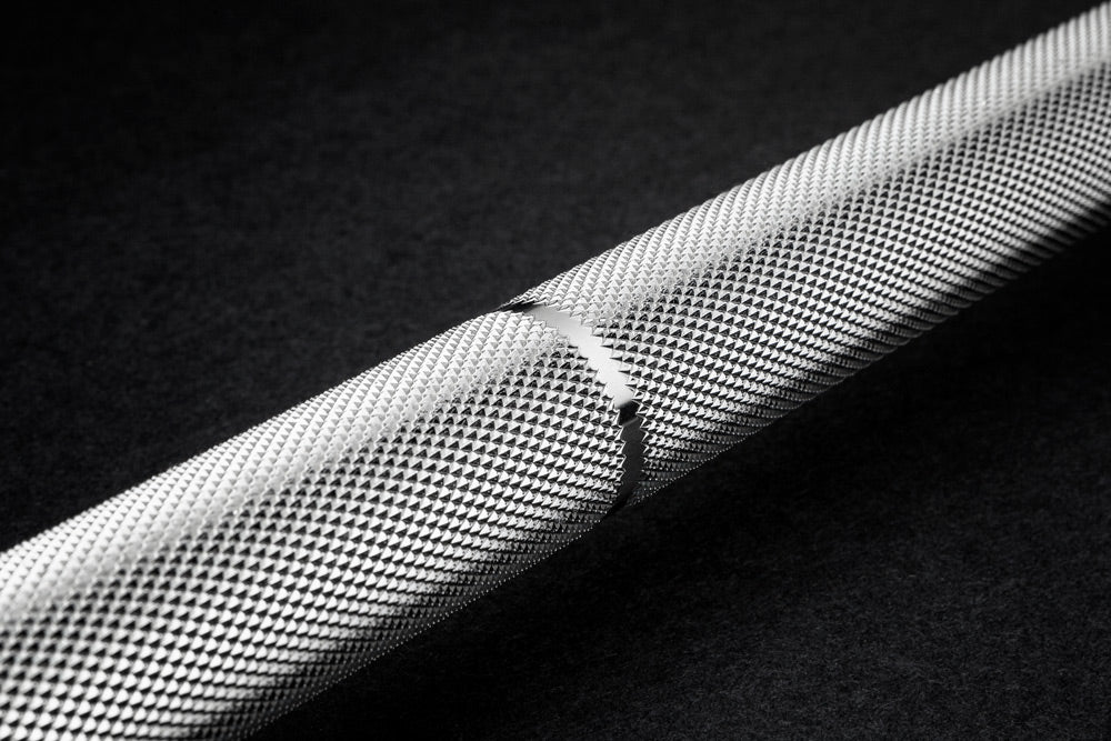 Close-up of a textured metal rod on a dark background
